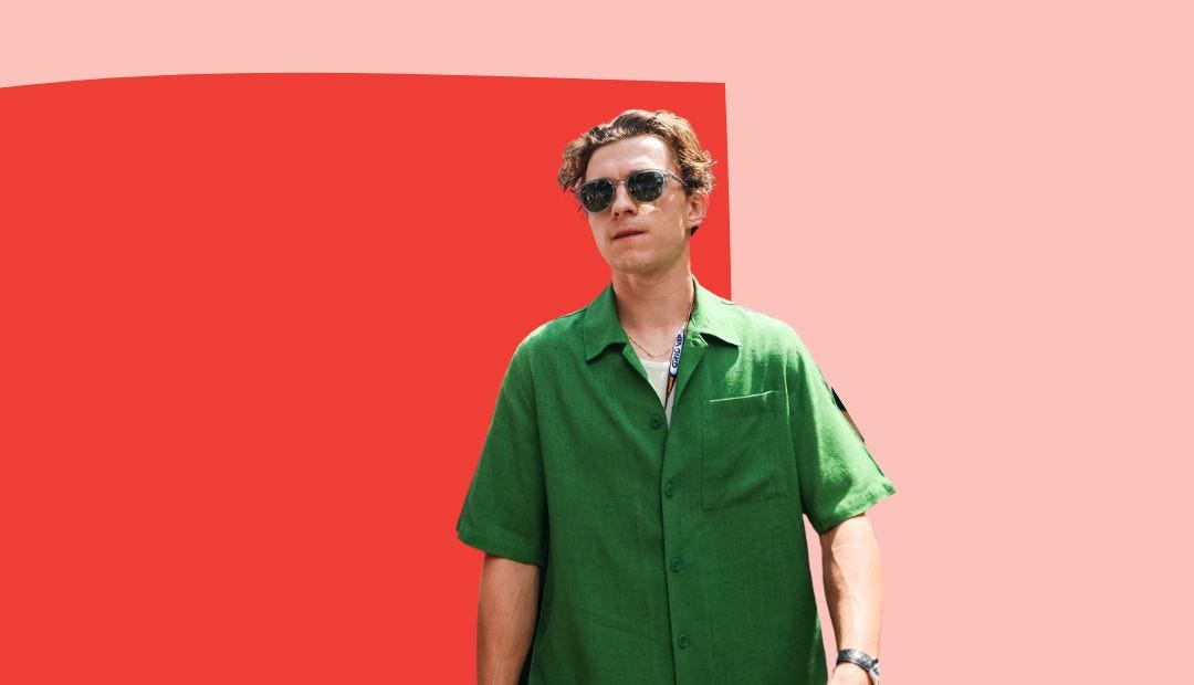 image of tom holland wearing a short-sleeve green shirt and sunglasses against a pink and red abstract background