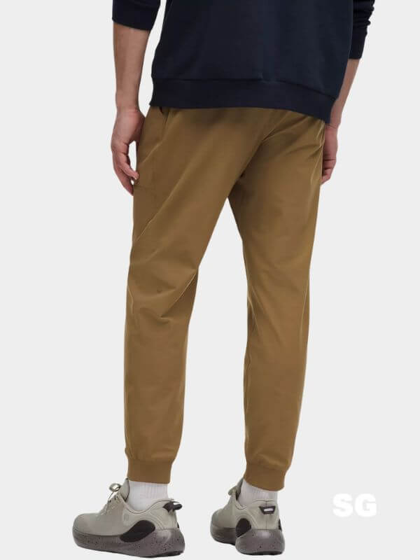 man from behind wearing brown joggers and a dark t-shirt