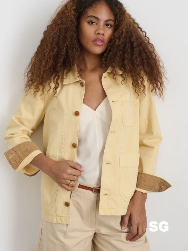 stylish woman wearing a butter yellow work jacket