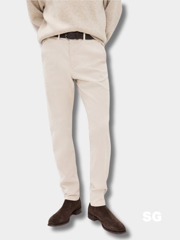 man from the waist down wearing light tan chinos with a brown belt and brown boots