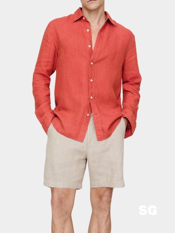 stylish man wearing a casual red linen shirt with khaki shorts