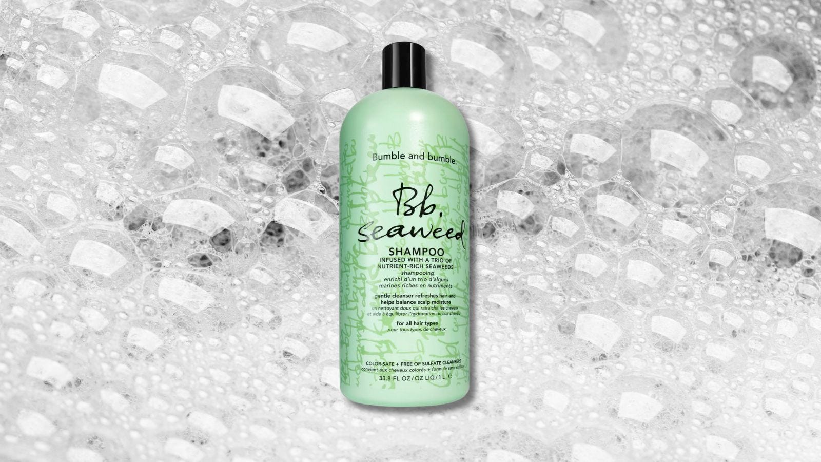 bottle of shampoo in a green container set against a background of soapy bubbles