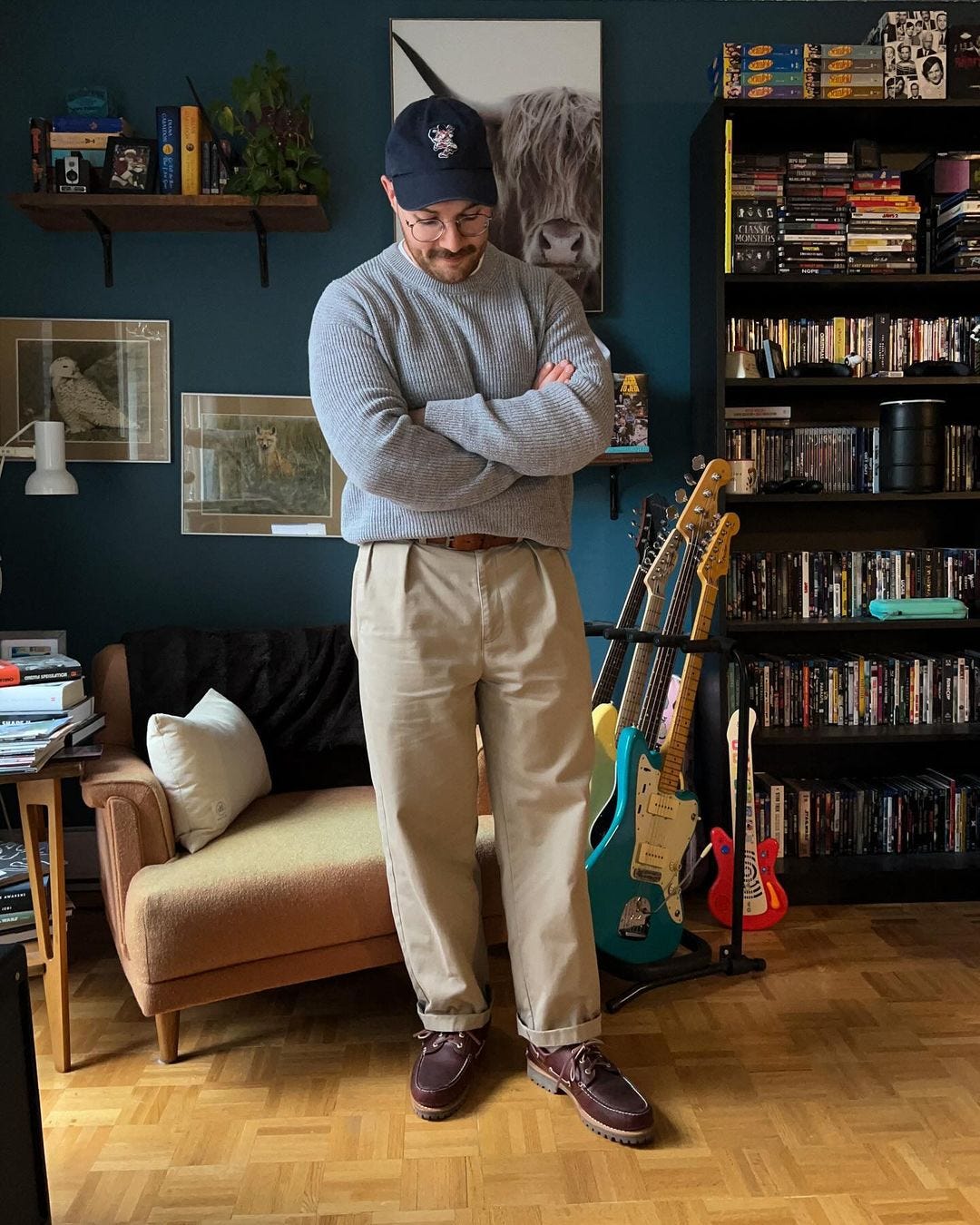 stylish man wearing a grey crewneck sweater with tan chinos and brown leather boat shoes
