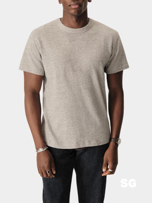 man from the neck down wearing a grey crewneck t-shirt and dark jeans