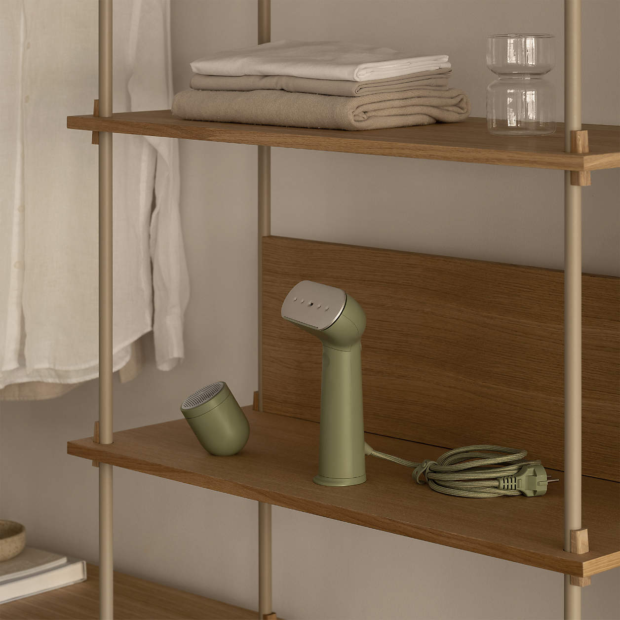 handheld steamer on a closet shelf