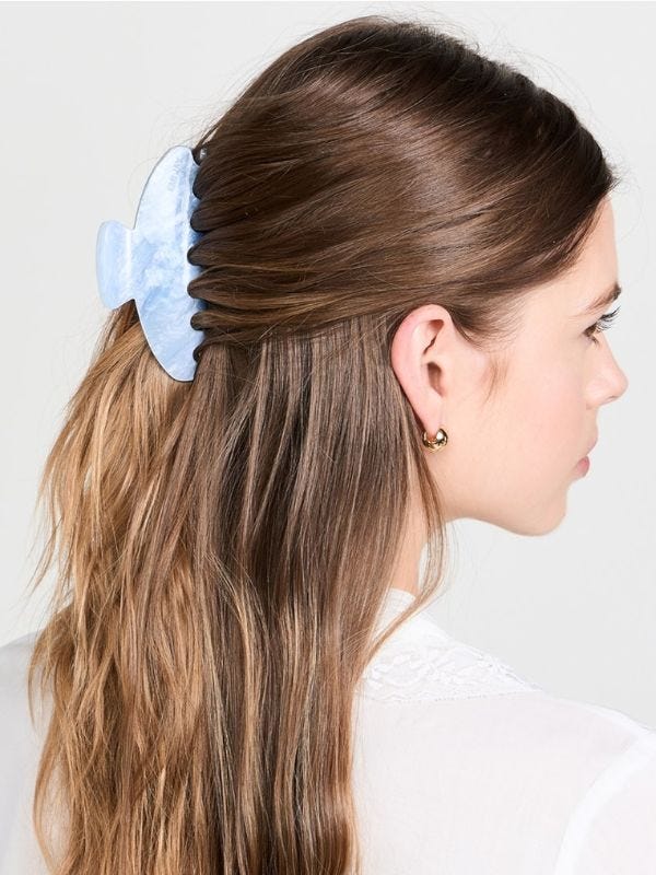 women wearing a large blue claw clip in her hair