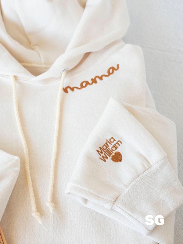 cream-colored hoodie with "mama" stitched at collar