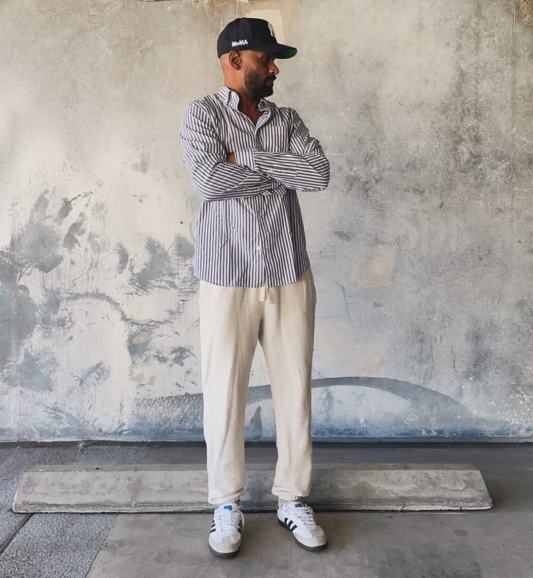 stylish man wearing white Adidas Samba sneakers with black stripes