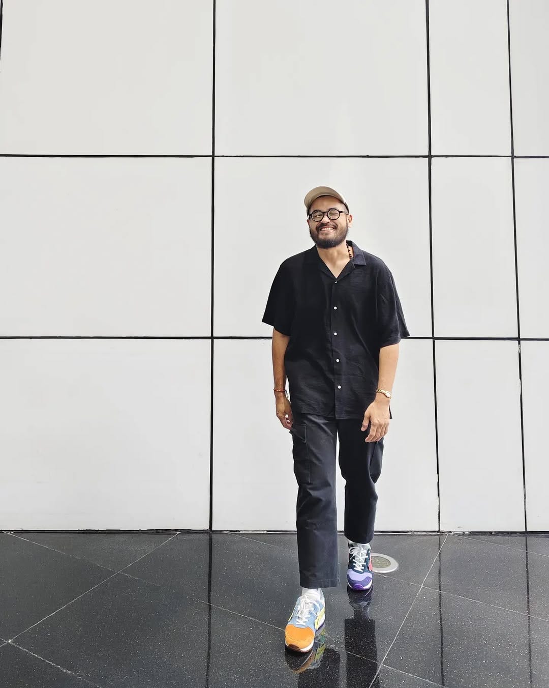 stylish man wearing a casual all-black outfit with sneakers