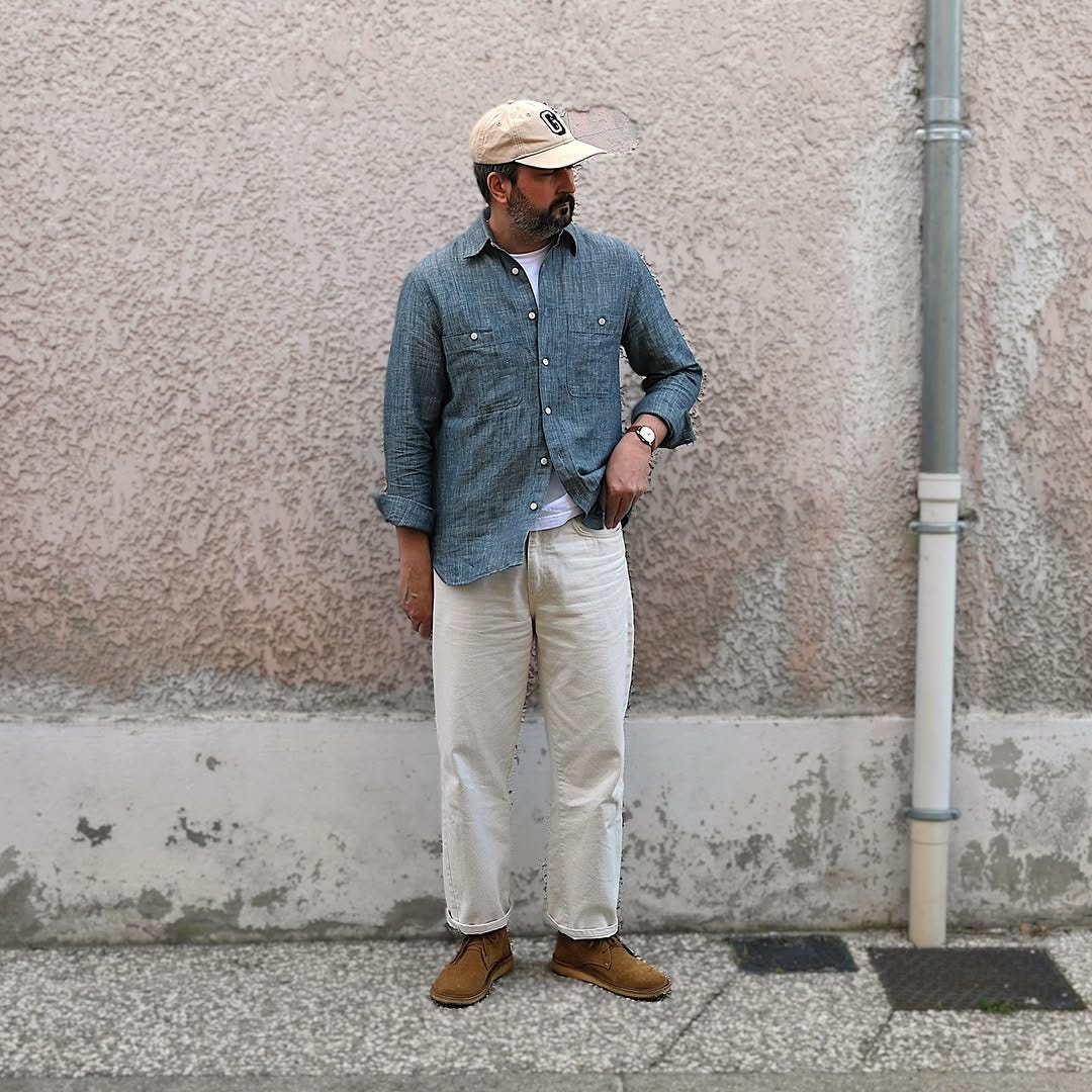 stylish man wearing a chambray shirt with off-white pants