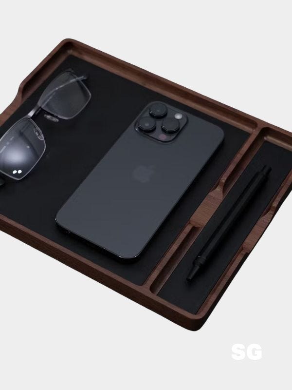 valet tray holding an iphone and black sunglasses