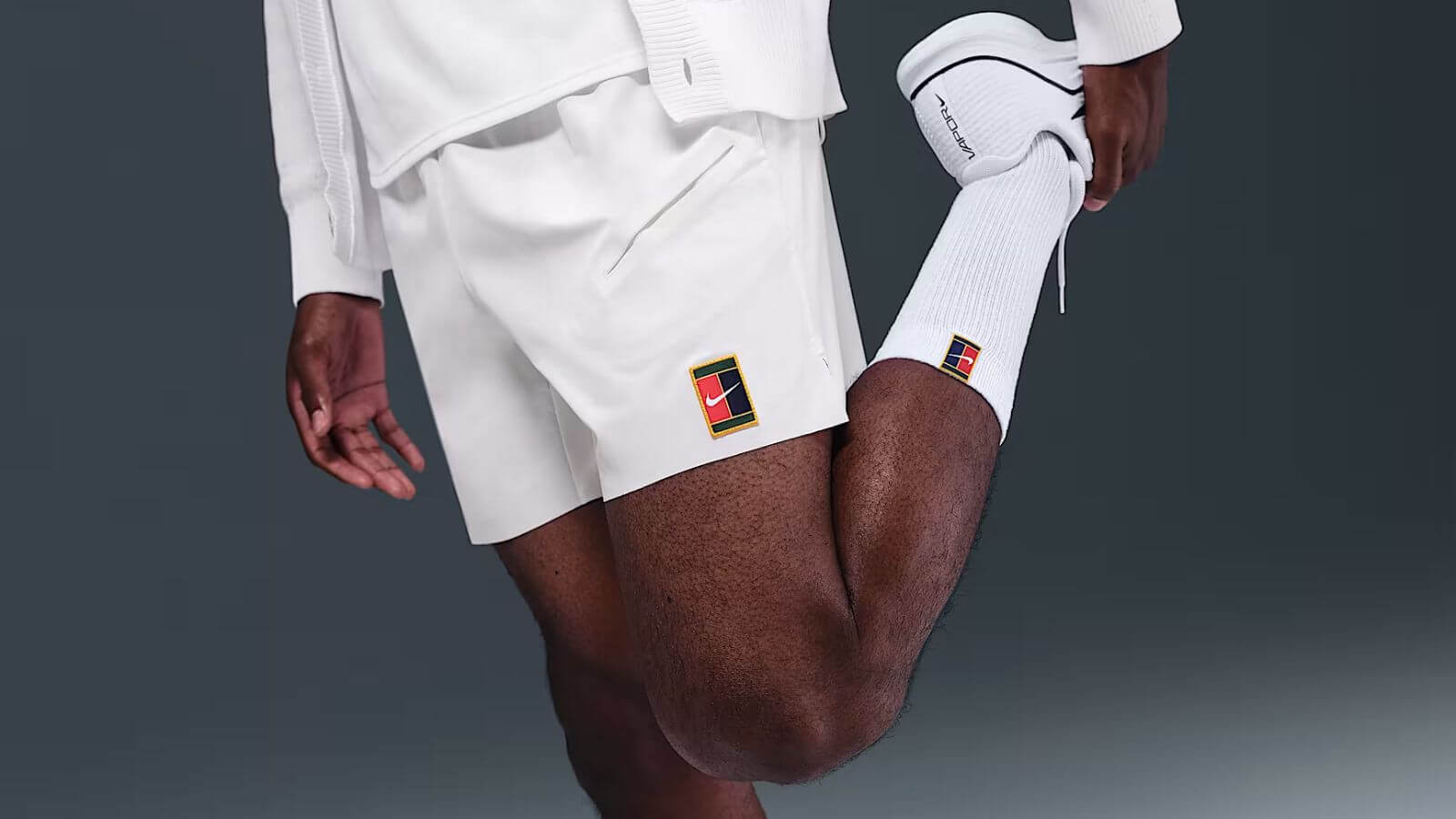 close-up of a man wearing white nike tennis shorts