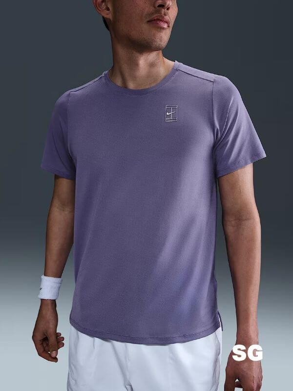 man wearing a purple shirt with the nike tennis logo