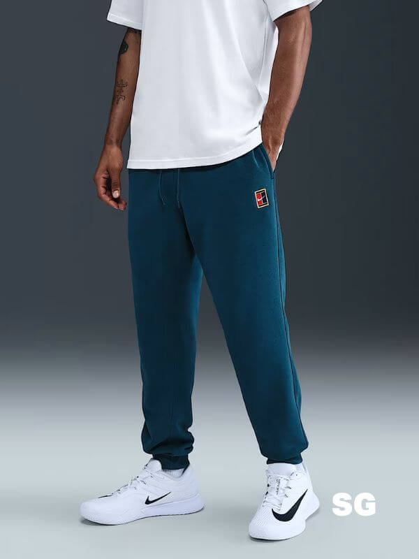 man from the waist down wearing green nike tennis joggers and white sneakers