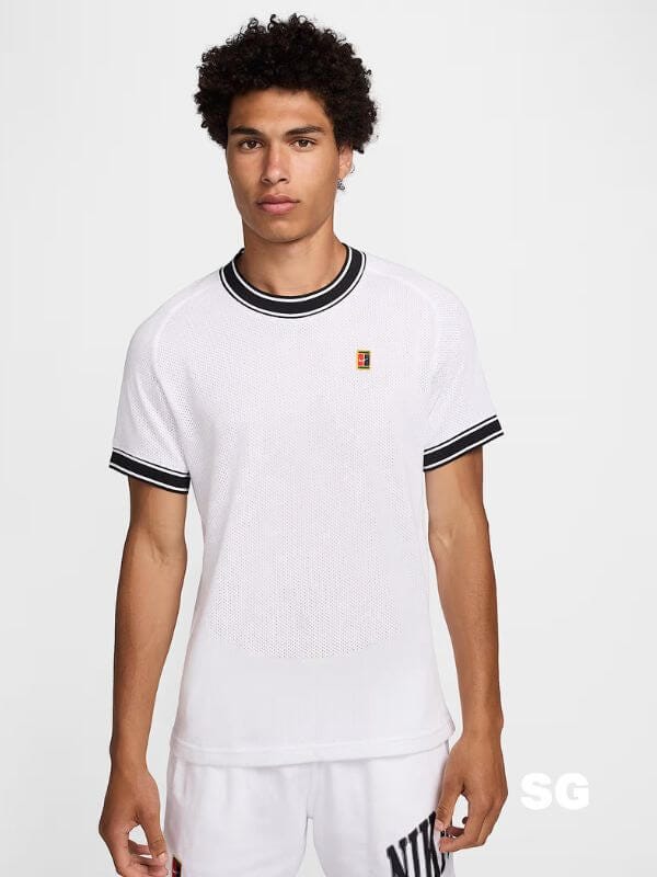 man wearing a white nike tennis shirt with black detailing at the neck and arms