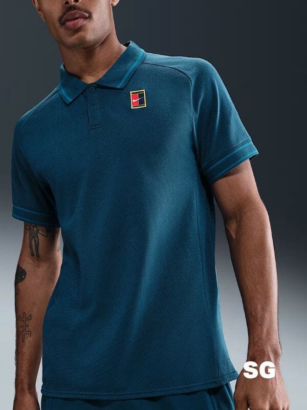 close-up of a man wearing a blue-green nike tennis polo shirt
