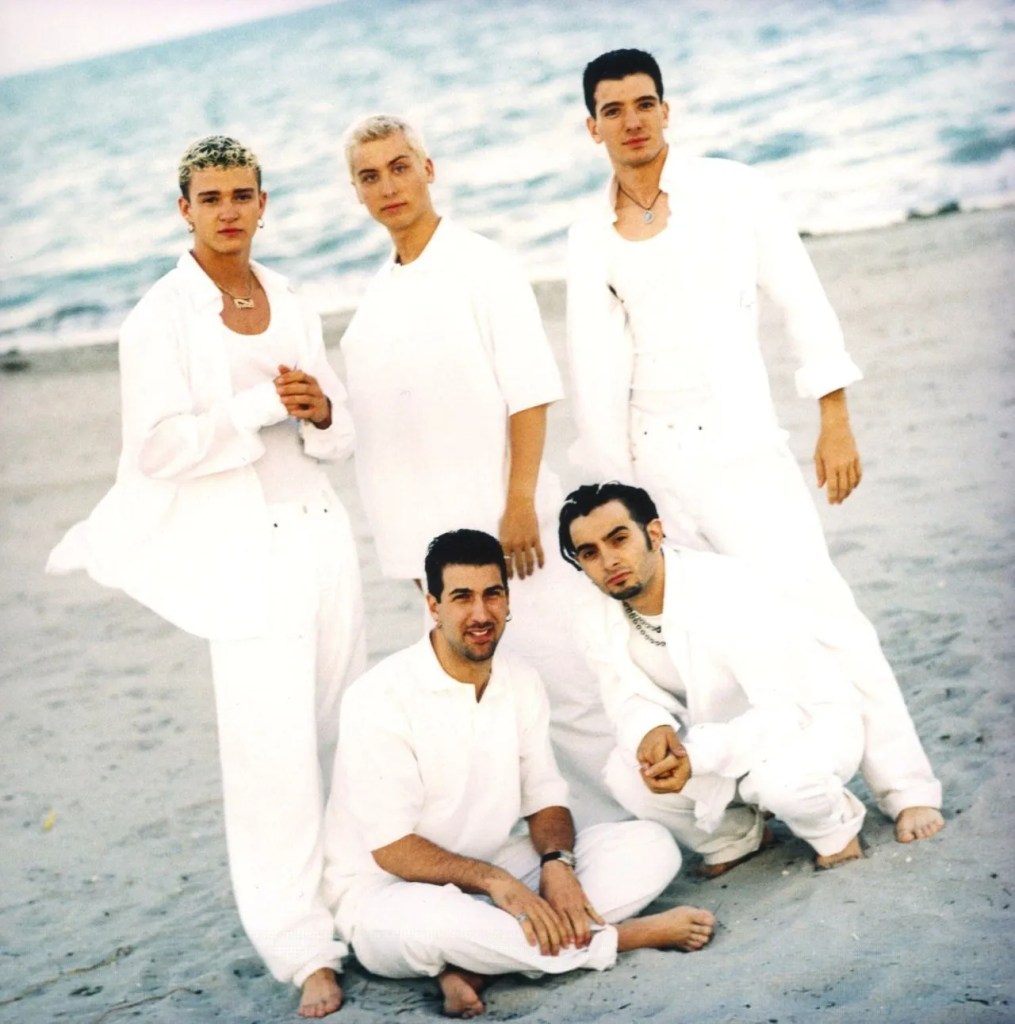 the band nsync wearing linen shirts on a beach