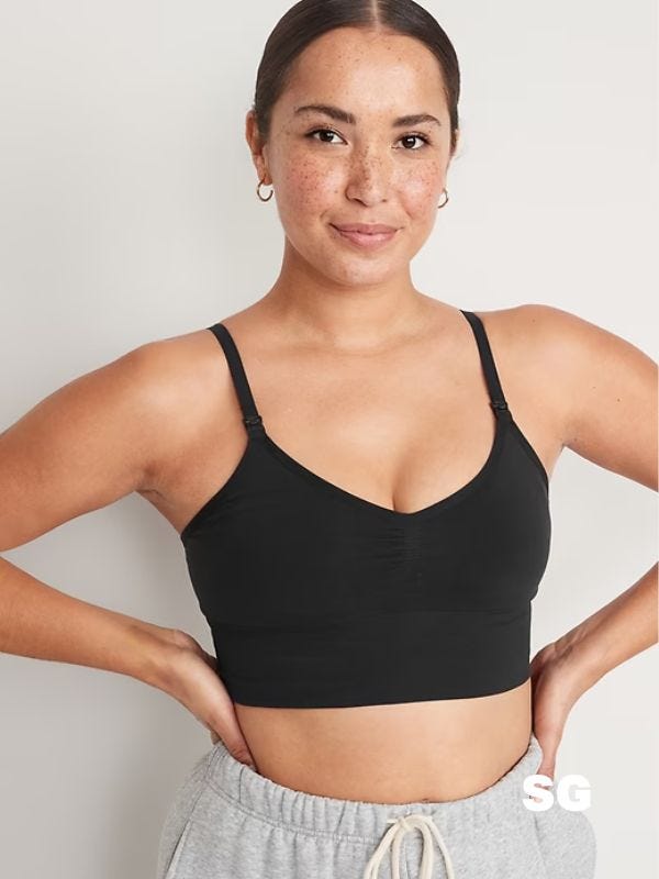 woman wearing a black hands-free pumping bra and grey sweatpants