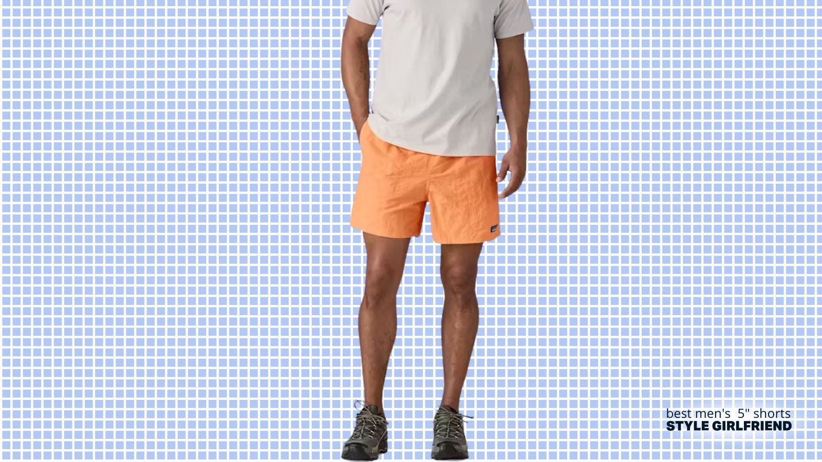 man from the chest down wearing a plain t-shirt with orange patagonia baggies and grey hiking sneakers
