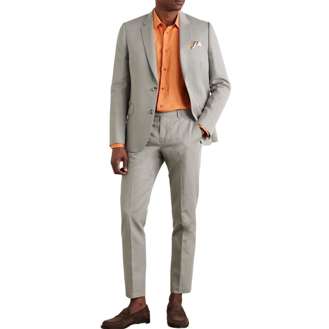 man from the neck down wearing a grey-green linen-blend suit with an orange dress shirt