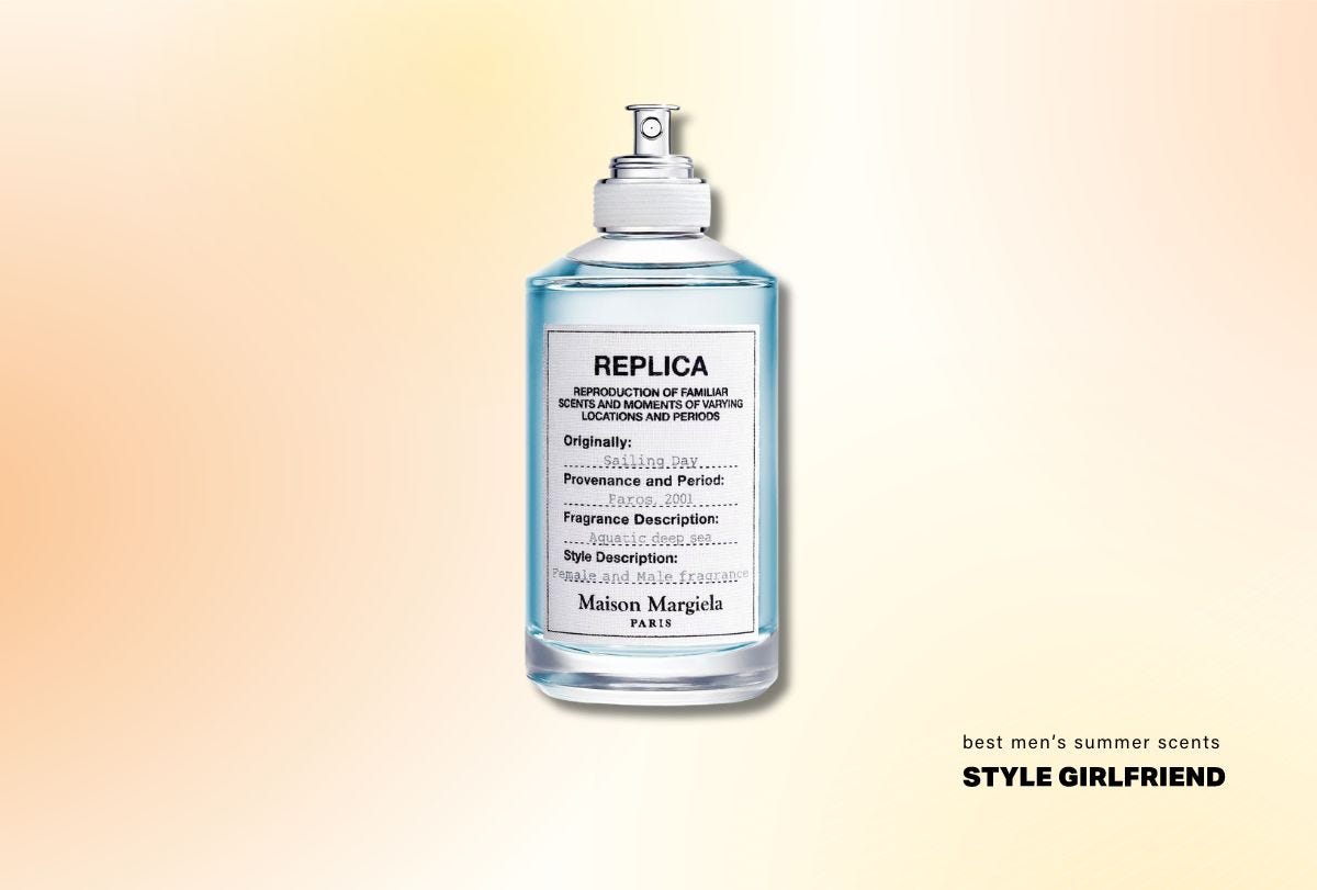 round bottle of fragrance with blue liquid inside, a white label with black lettering, and a silver nozzle