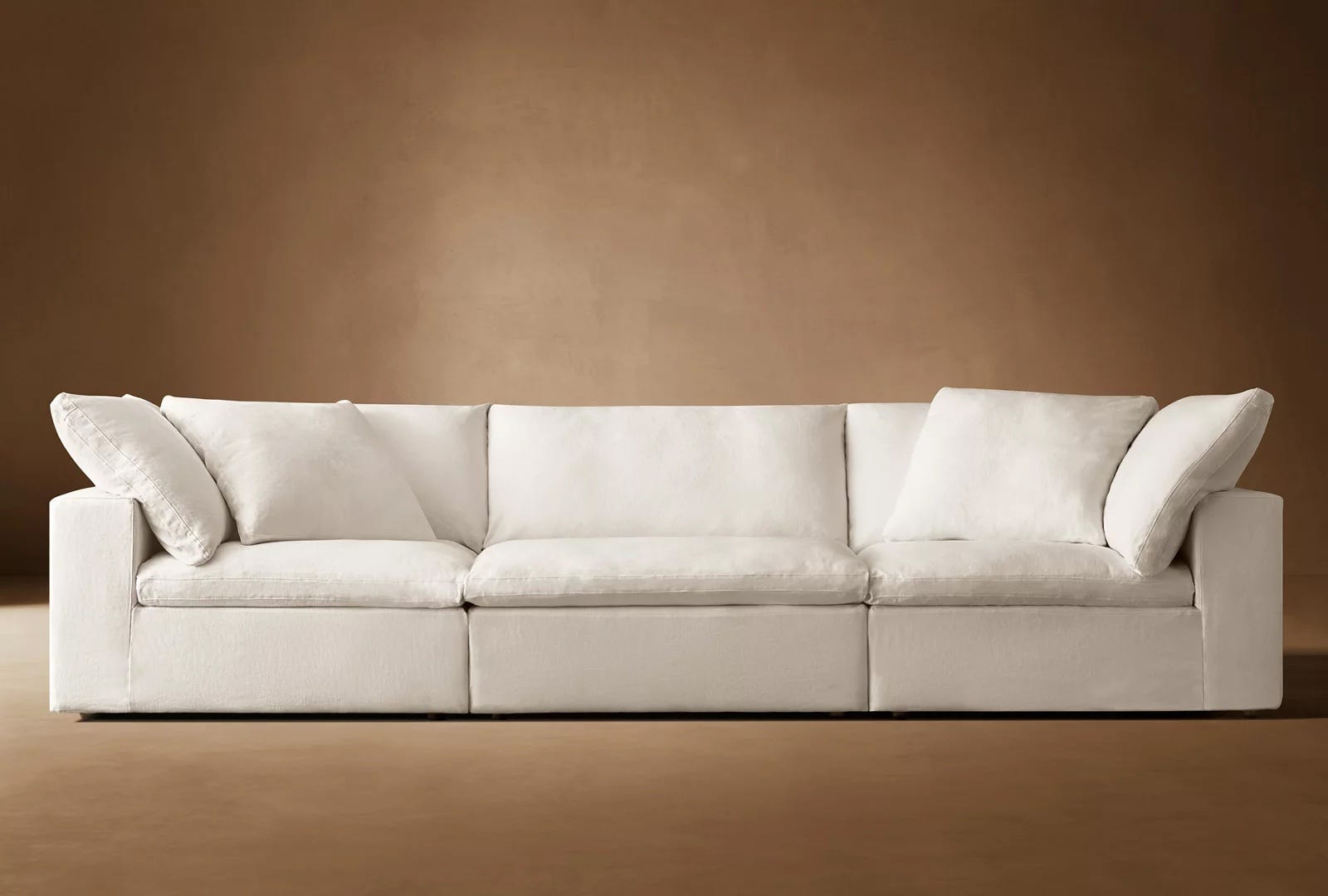 white couch set against a brown background