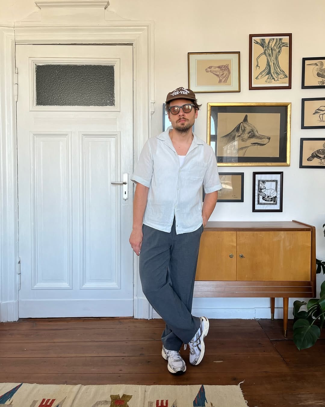 stylish man wearing a camp shirt with pants and sneakers