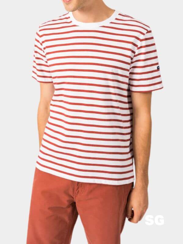 close-up of a man wearing a short-leeve red and white striped breton tee