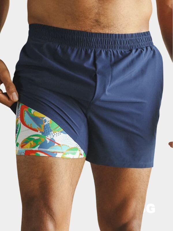close-up of a man wearing navy shorts showing a patterned lining underneath