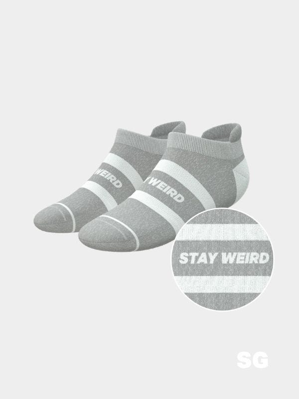 grey ankle socks that say "get weird" across the top of the foot