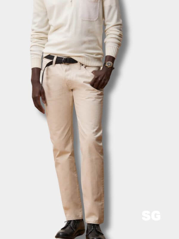 man from the chest down wearing a white sweater and white jeans