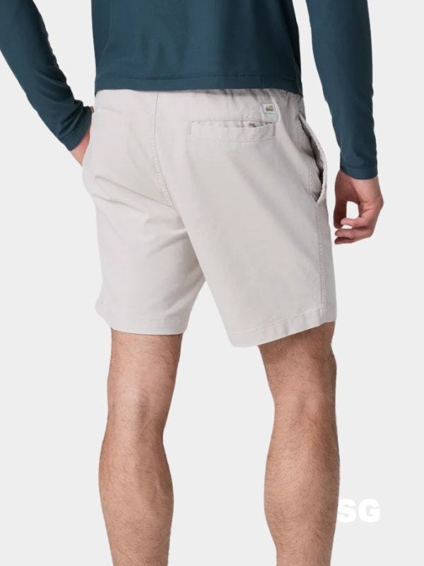 man from the back wearing corduroy shorts and a navy long-sleeve shirt