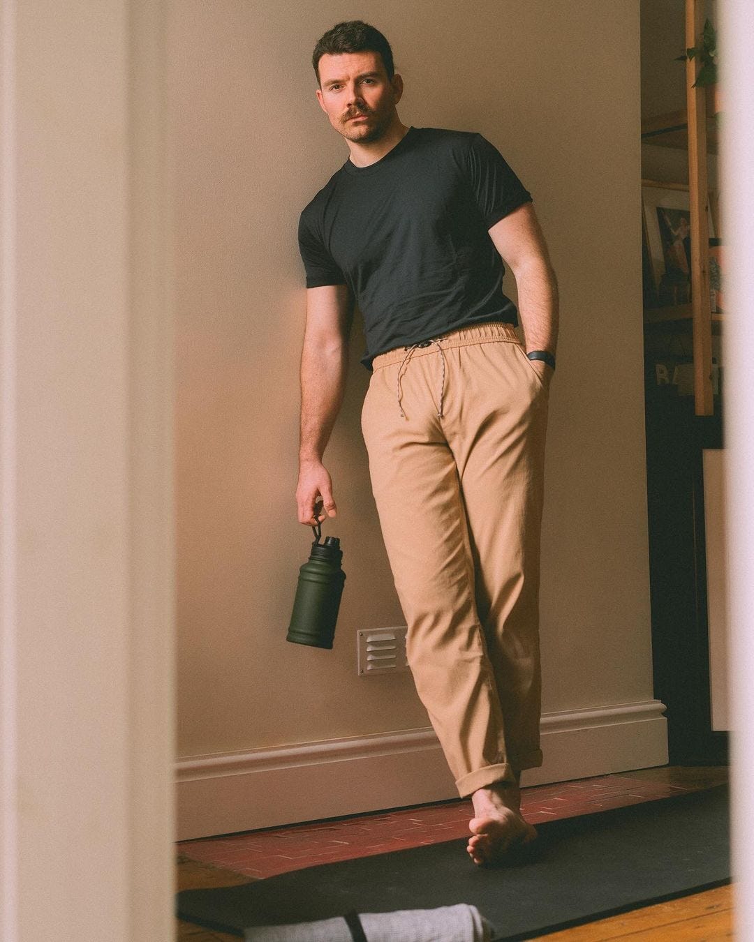 stylish man wearing a black t-shirt and drawstring jogger pants
