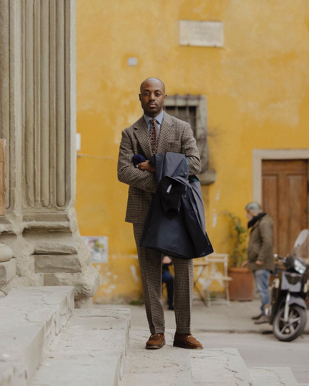 stylish man wearing a patterned suit with shirt and tie